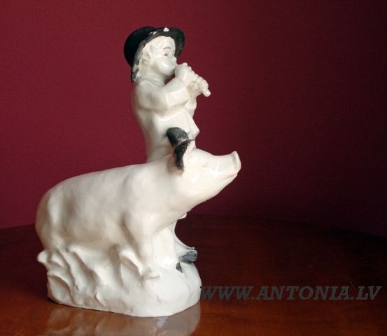 A figure of a swain with the pig